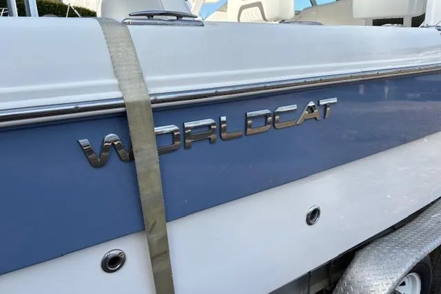 Slide: The Image of 2023 World Cat 230 DC boat side view with logo and strap. - 9