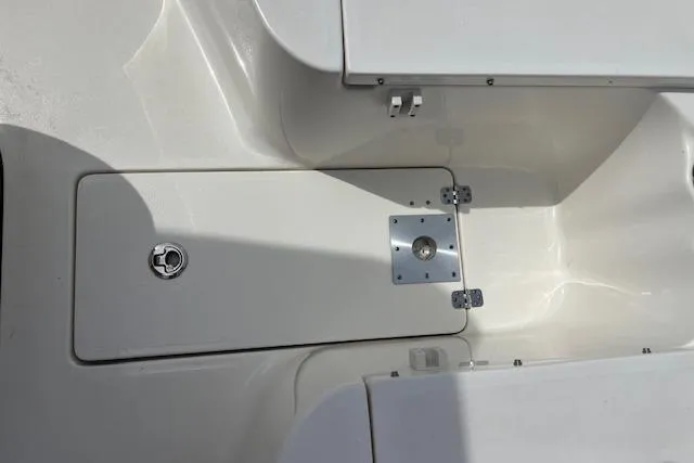 Slide: The Image of 2021 Key West 239 FS boat deck with storage compartment and latch. - 11