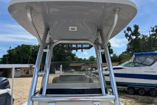 Slide: The Image of 2021 Key West 239 FS boat with T-top and seating, parked outdoors. - 12