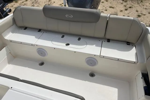 Slide: The Image of 2021 Key West 239 FS boat interior with cushioned seating and storage compartments. - 2