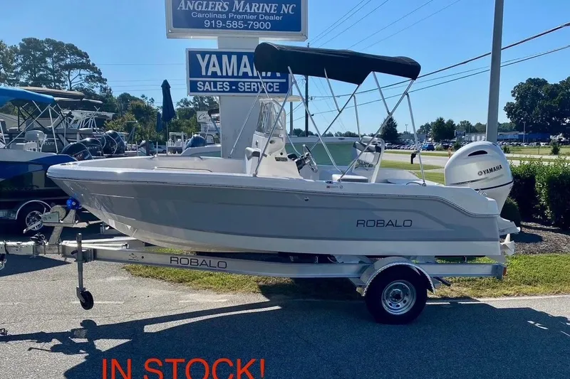 The Image of 2026 Robalo R160 Center Console boat on trailer at dealership, available for sale. - 0