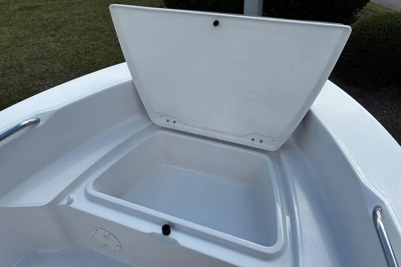 Slide: The Image of Open storage compartment on 2026 Robalo R160 Center Console boat. - 11