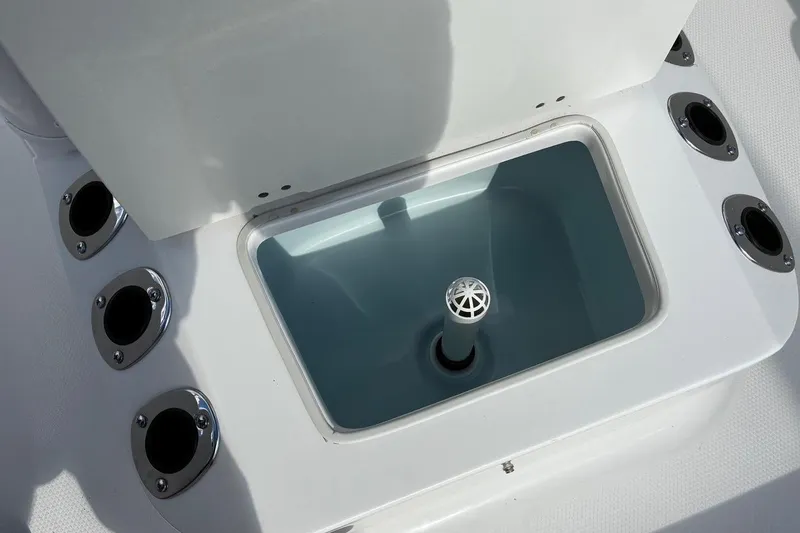 Slide: The Image of Livewell compartment on 2026 Robalo R160 Center Console boat, surrounded by rod holders. - 12