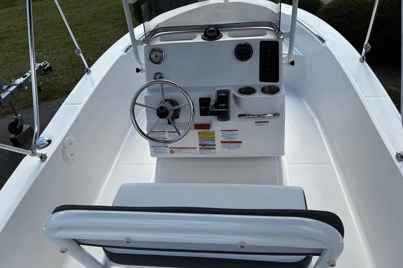 Slide: The Image of 2026 Robalo R160 Center Console boat interior with steering wheel and control panel. - 3