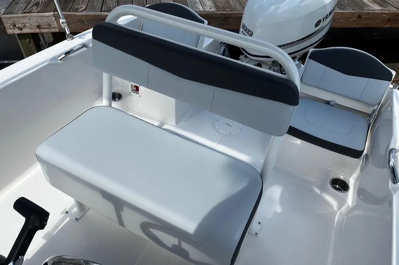 Slide: The Image of 2026 Robalo R160 Center Console boat interior with seating and Yamaha engine. - 9