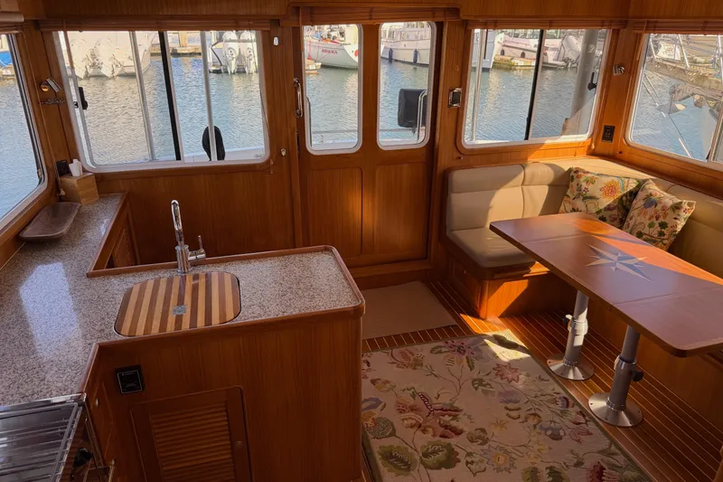 Slide: The Image of Luxurious interior of 2020 Helmsman Trawlers 38E with elegant wood finishes and waterfront view. - 12