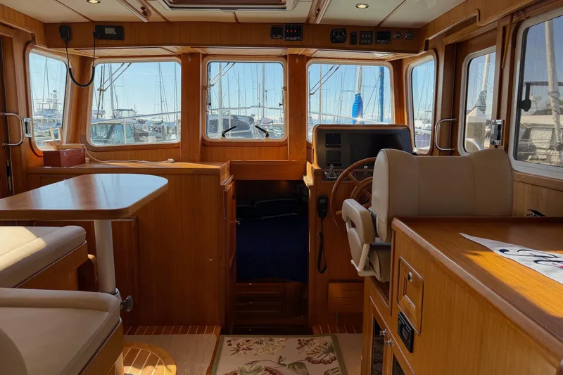 Slide: The Image of Interior of 2020 Helmsman Trawlers 38E, featuring wood finishes and helm station. - 13