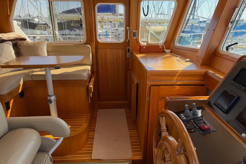Slide: The Image of Helmsman Trawlers 38E 2020 interior with wooden finish and seating area. - 15
