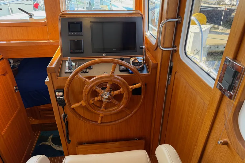 Slide: The Image of Helmsman Trawlers 38E 2020 helm station with wooden wheel and navigation equipment. - 17