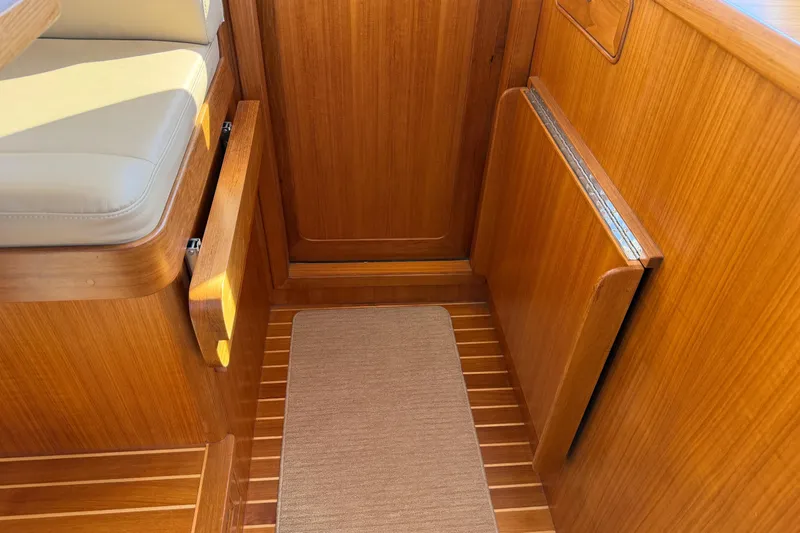 Slide: The Image of Helmsman Trawlers 38E 2020 interior with wooden finish and cushioned seating. - 20
