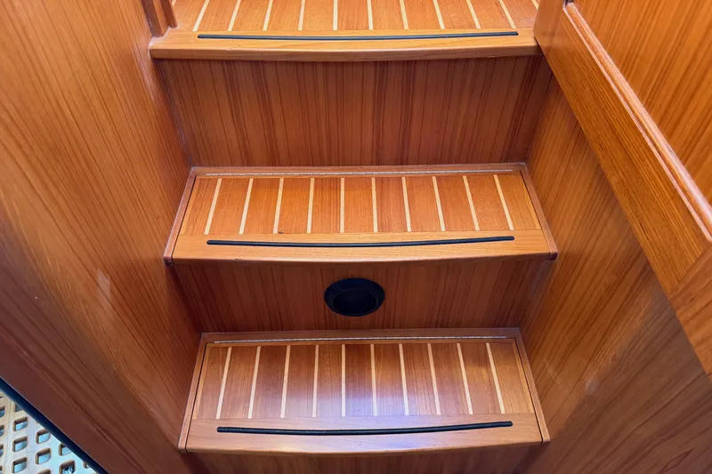 Slide: The Image of Wooden stairs inside a 2020 Helmsman Trawlers 38E boat, featuring sleek design. - 29