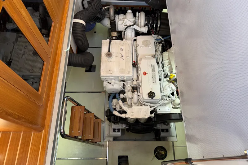 Slide: The Image of Engine room of 2020 Helmsman Trawlers 38E, showcasing a clean, organized marine engine setup. - 30