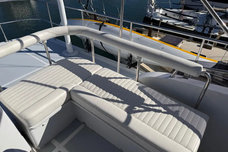 Slide: The Image of Helmsman Trawlers 38E 2020 model with white cushioned seating on deck. - 34