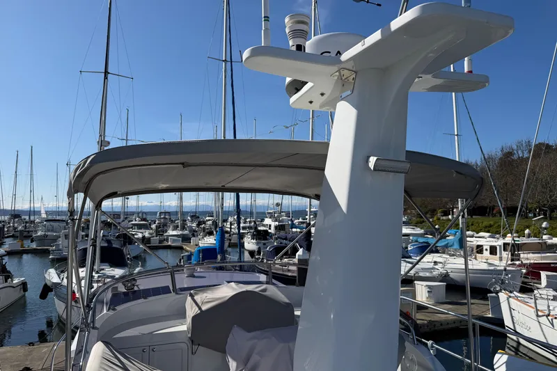 Slide: The Image of 2020 Helmsman Trawlers 38E yacht docked in a marina under clear blue skies. - 36