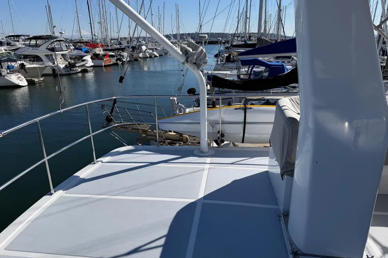 Slide: The Image of Helmsman Trawlers 38E 2020 model docked at a marina with sailboats. - 37