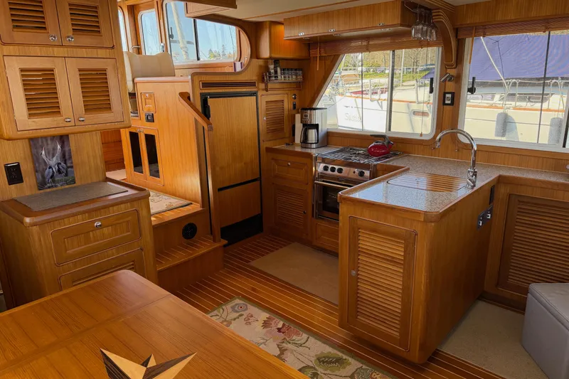 Slide: The Image of Luxurious 2020 Helmsman Trawlers 38E interior with wood finish and modern kitchen amenities. - 4