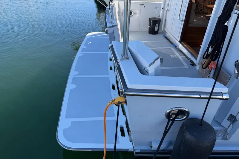 Slide: The Image of Helmsman Trawlers 38E 2020 model, featuring a spacious swim platform and dockside connection. - 40