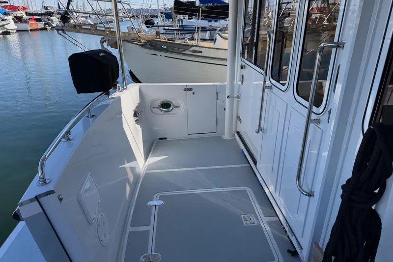 Slide: The Image of 2020 Helmsman Trawlers 38E yacht deck with marina view. - 41