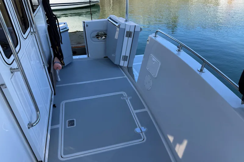 Slide: The Image of Helmsman Trawlers 38E 2020 model boat deck with open door and railing. - 42