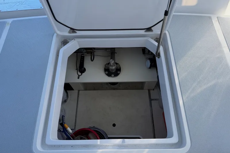 Slide: The Image of Open hatch on 2020 Helmsman Trawlers 38E, revealing storage compartment and mechanical components. - 43