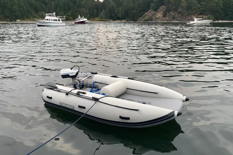 Slide: The Image of Inflatable boat on calm water with Helmsman Trawlers 38E in the background, 2020 model. - 47