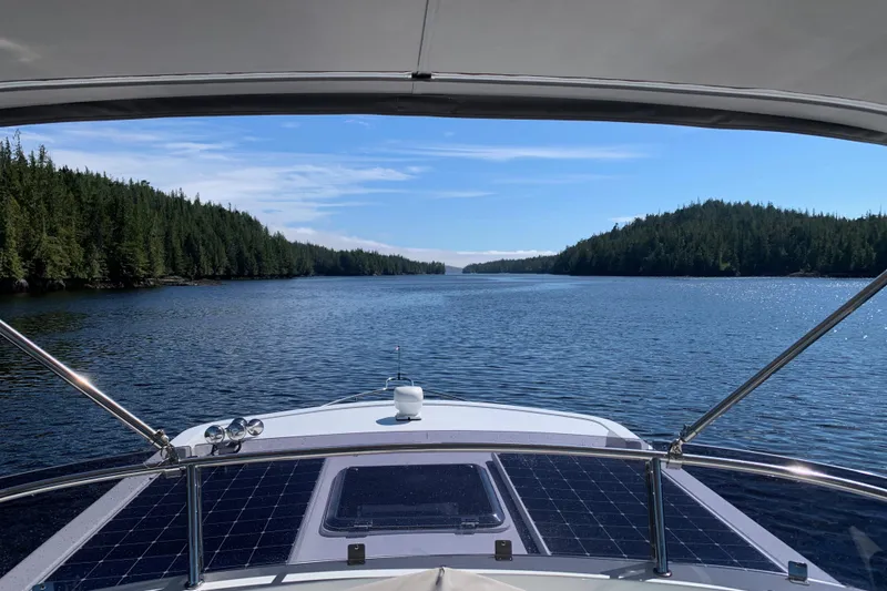 Slide: The Image of Helmsman Trawlers 38E cruising through scenic forested waterway, 2020 model. - 49