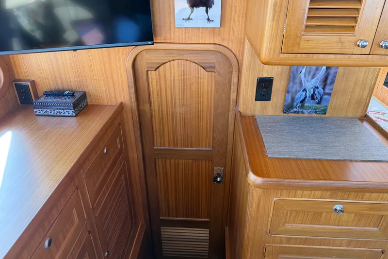 Slide: The Image of Helmsman Trawlers 38E 2020 interior with wooden cabinetry and wall art. - 8