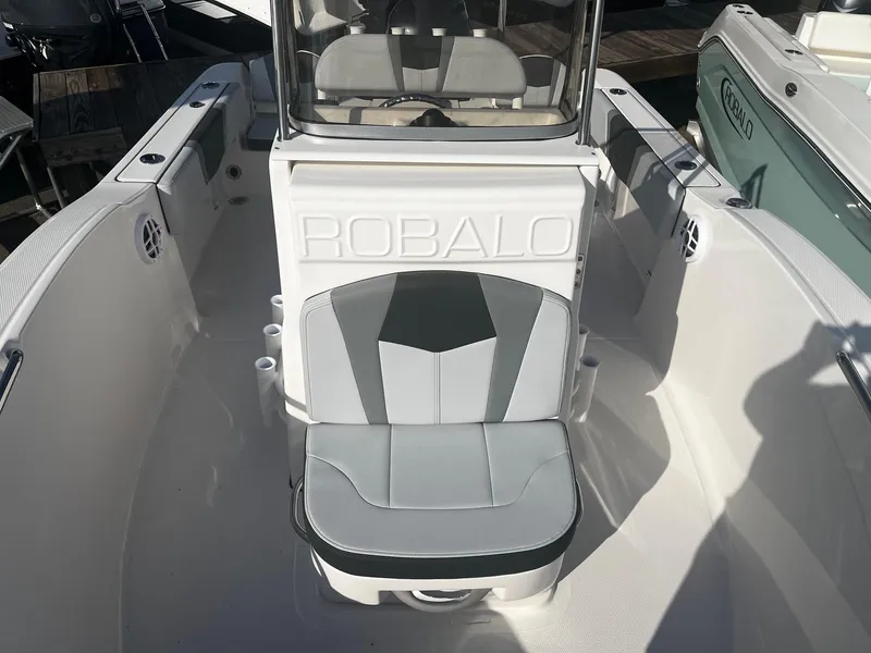 Slide: The Image of 2025 Robalo R180 Center Console boat interior with cushioned seating. - 12