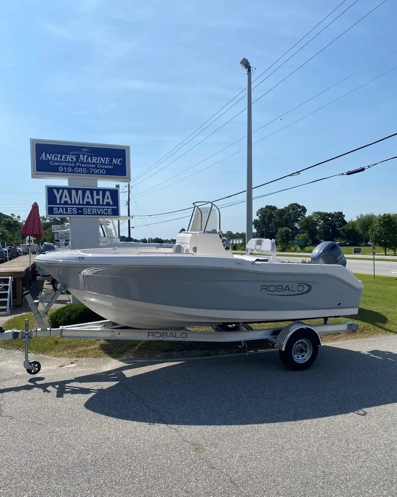 Slide: The Image of 2025 Robalo R180 Center Console boat on trailer at Angler's Marine dealership. - 17
