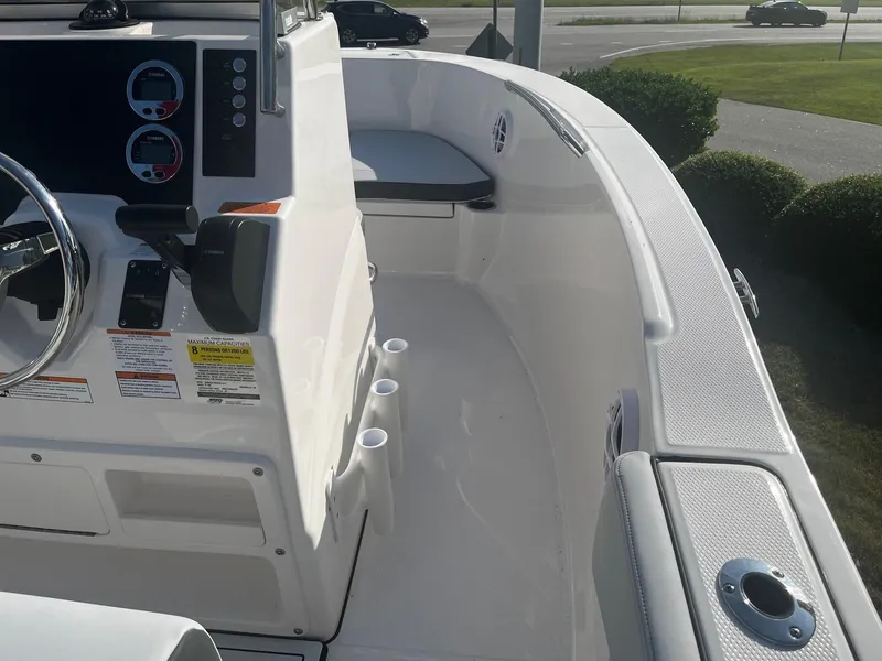 Slide: The Image of 2025 Robalo R180 Center Console boat interior with steering wheel and seating area. - 3