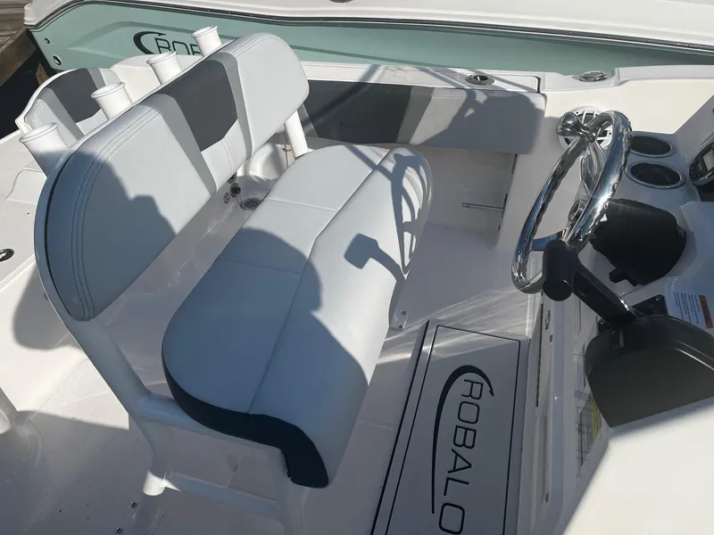 Slide: The Image of 2025 Robalo R180 Center Console boat interior with steering wheel and seating. - 6