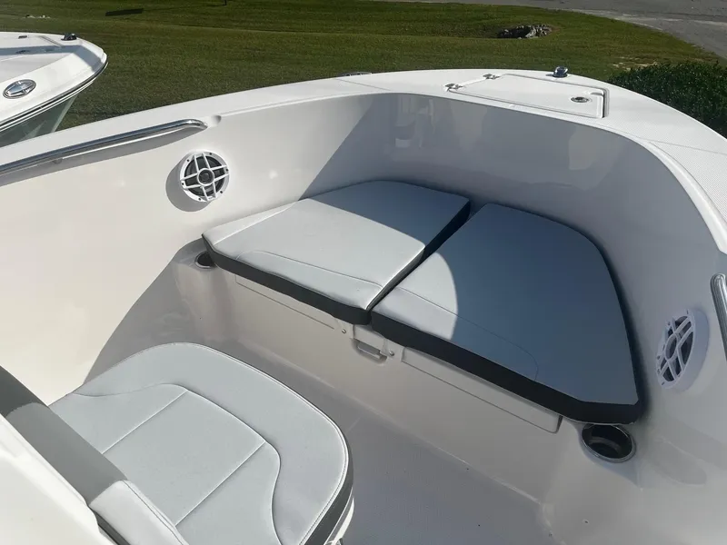 Slide: The Image of 2025 Robalo R180 Center Console boat interior with cushioned seating and cup holders. - 8