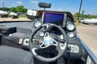 Slide: The Image of Steering wheel and dashboard of a 2011 Nitro Z-8 boat with navigation display. - 4