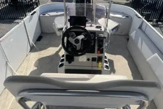 Slide: The Image of 2023 Suntracker G3 Select 322 CC boat interior with steering console and seating. - 11