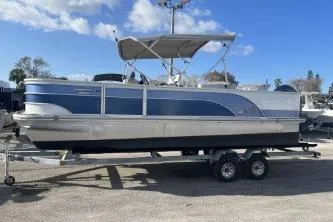 Slide: The Image of 2023 Suntracker G3 Select 322 CC pontoon boat on trailer, blue and silver design. - 5