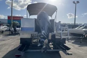 Slide: The Image of 2023 Suntracker G3 Select 322 CC boat, rear view, parked outdoors under sunny sky. - 6