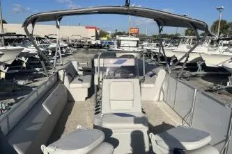 Slide: The Image of 2023 Suntracker G3 Select 322 CC pontoon boat with spacious seating and canopy in a marina. - 7
