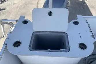 Slide: The Image of 2023 Suntracker G3 Select 322 CC boat console with storage compartment and cup holders. - 9