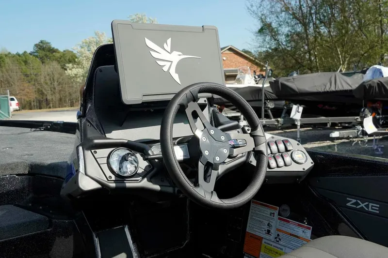 Slide: The Image of 2026 Skeeter ZXE21 boat dashboard with steering wheel and control panel. - 10
