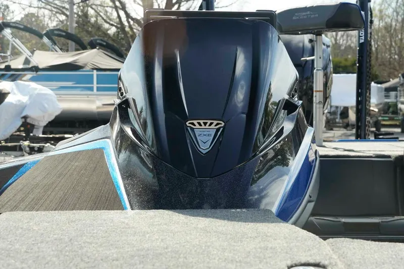 Slide: The Image of 2026 Skeeter ZXE21 boat, sleek design, black and blue color, outdoor setting. - 15