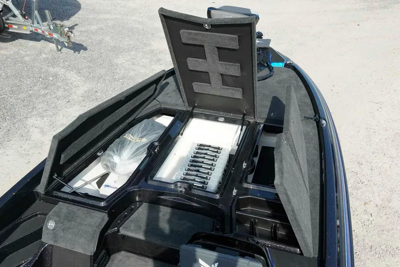 Slide: The Image of 2026 Skeeter ZXE21 boat storage compartments with organized tackle trays and equipment. - 19