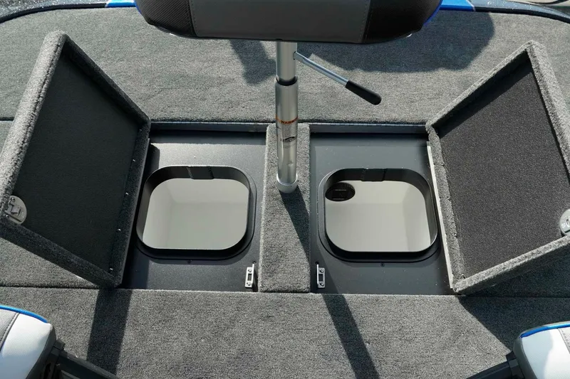 Slide: The Image of 2026 Skeeter ZXE21 boat storage compartments with open lids and seating. - 23