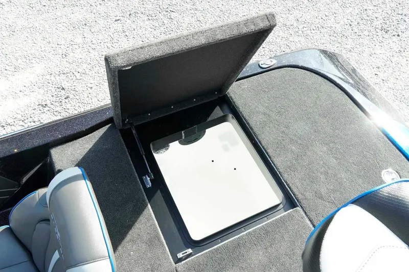 Slide: The Image of 2026 Skeeter ZXE21 boat storage compartment with open lid, showcasing interior space. - 26