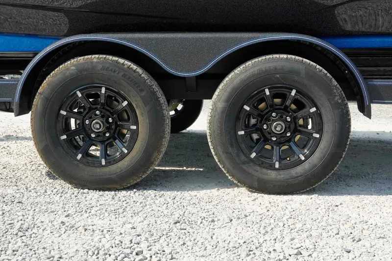 Slide: The Image of Trailer wheels of a 2026 Skeeter ZXE21 on gravel surface. - 33