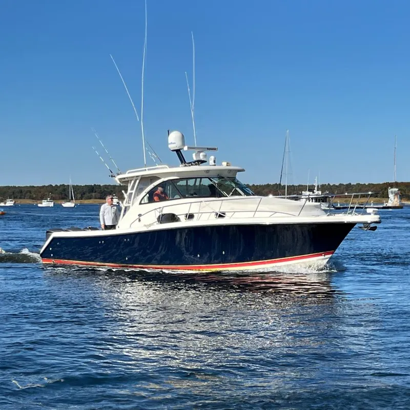 The Image of 2009 Pursuit OS 375 Offshore boat cruising on a calm blue sea. - 0