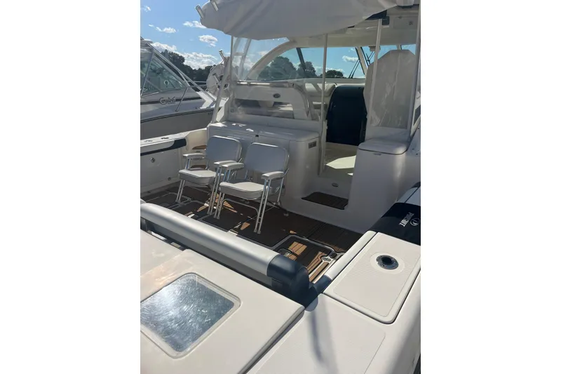 Slide: The Image of 2009 Pursuit OS 375 Offshore boat interior with seating and deck view. - 10