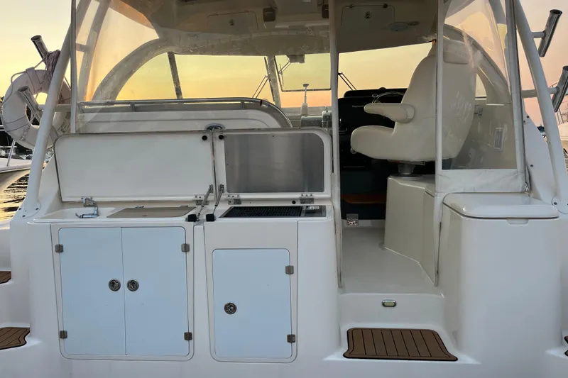 Slide: The Image of 2009 Pursuit OS 375 Offshore boat interior with helm seat and storage compartments. - 15