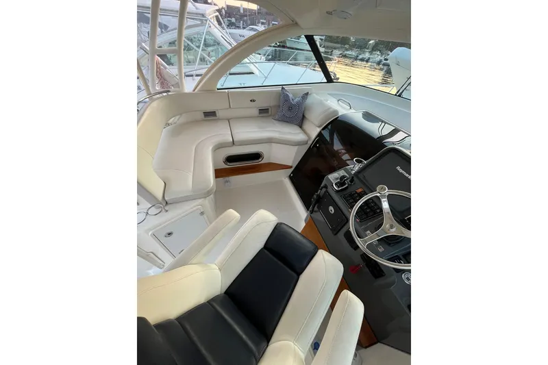 Slide: The Image of Interior of 2009 Pursuit OS 375 Offshore boat with helm and seating area. - 19