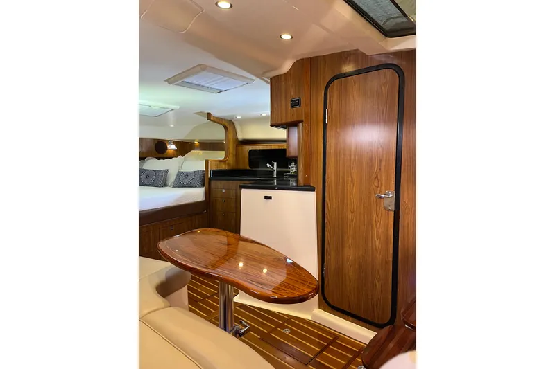 Slide: The Image of Luxurious interior of 2009 Pursuit OS 375 Offshore boat with wood finishes and cozy seating. - 21