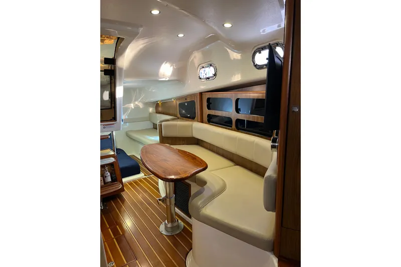 Slide: The Image of Luxurious interior of 2009 Pursuit OS 375 Offshore boat with elegant seating and wooden accents. - 22